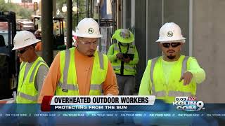 Outdoor workers protecting themselves from the heat, avoiding dehydration