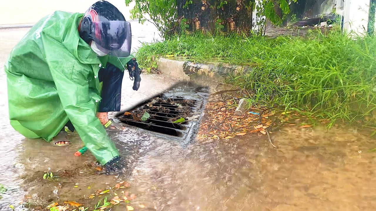 Unclogging Drains to Drain Massive Floods Streets by Unclogging - YouTube