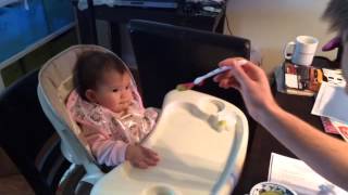 Baby Myla eating peas for the first time