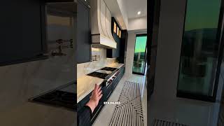 This is a Calcutta kitchen island with amazing views and even a prep kitchen with a hidden pantry