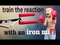 Fighter trains reaction on his own with an iron mitt