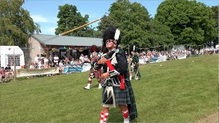 Drum Majors Mace flourish (spin) competition on the march during 2023 Oldmeldrum Highland Games