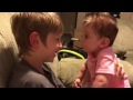 Big brother and baby sister talk to each other