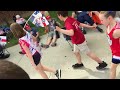 A group of 8-11-year-olds pep up the crowd awaiting Donald Trump's 100-day rally in Harrisburg.