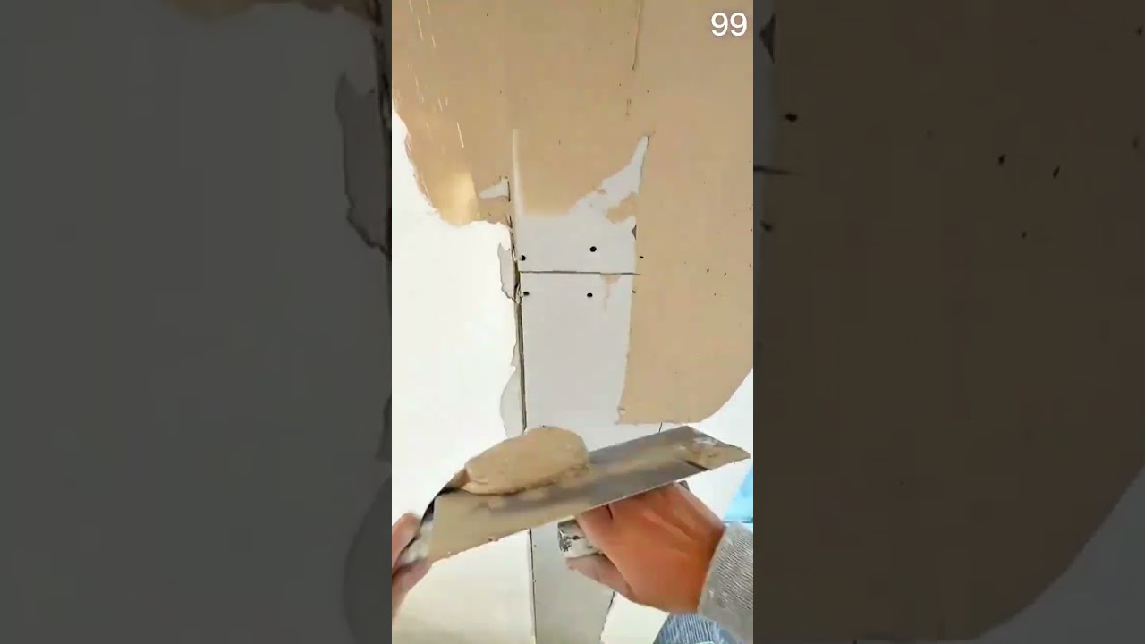 Putty knife glides compound fills drywall seam smoothened