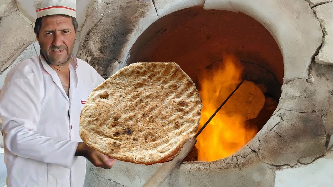 baking bread/This baker bakes tandoori bread in Asia/traditional bread