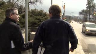 TV reporter walks into sign post