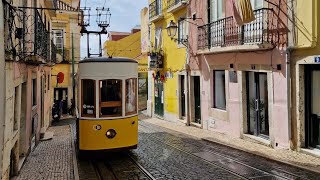 Lisbon - walking in the Rua da Bica de Duarte Belo street with the famous tram; 5th march 2023