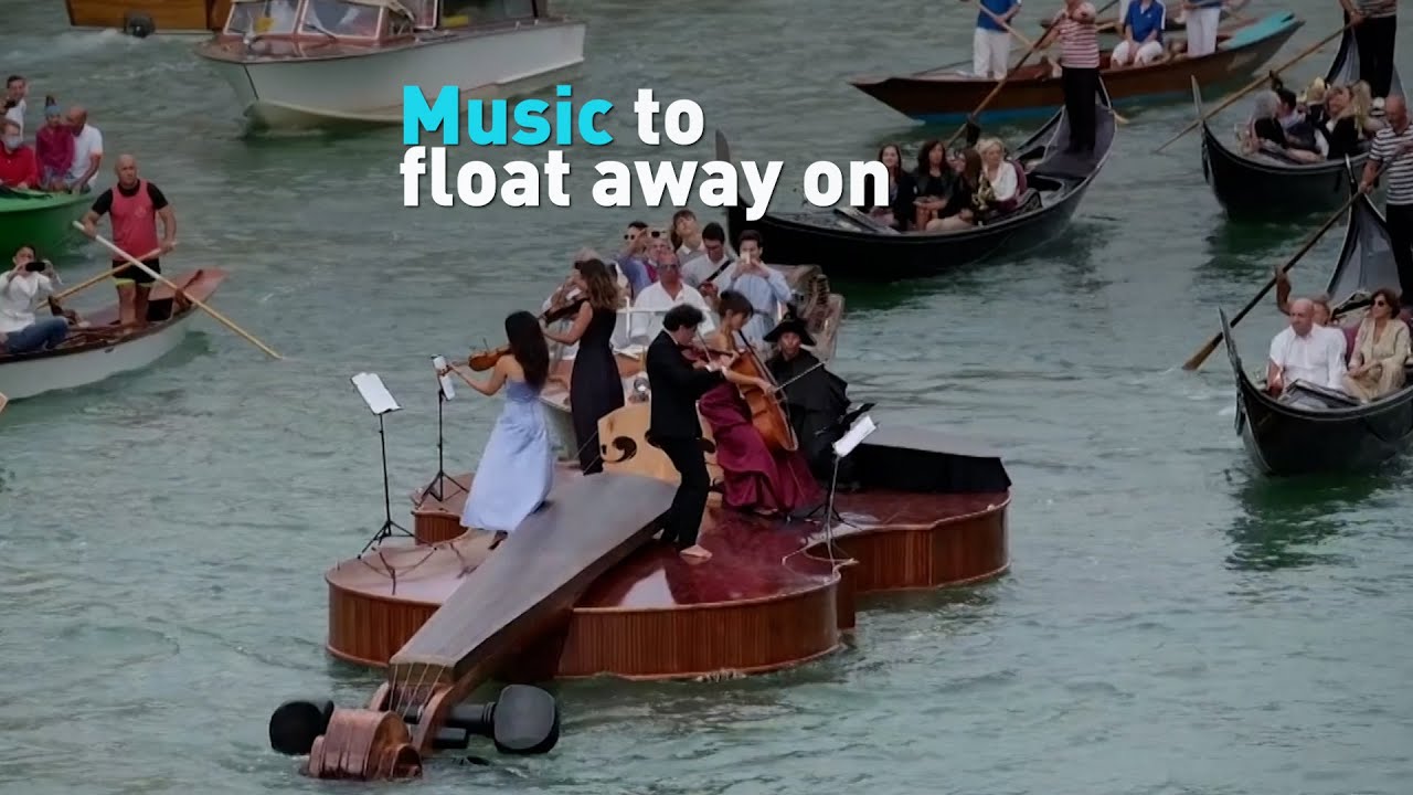 String quartet plays on giant floating violin in Venice, Italy