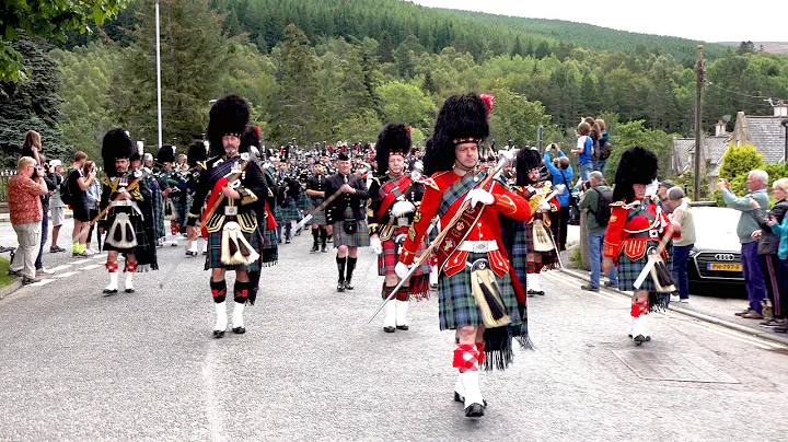 Massed pipes & drums parade through town to the 20...