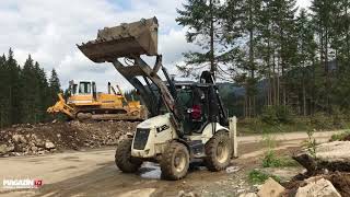 backhoe loader HIDROMEK HMK 102B loading clay to TATRA dump truck