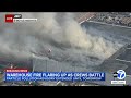 Los Angeles warehouse flare-up sends smoke into air