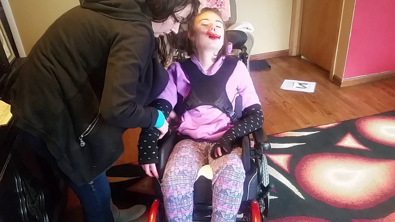 Strapping Bella into wheelchair without TLSO