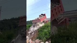 The process of unloading stones with a dump truck's tipping bucket