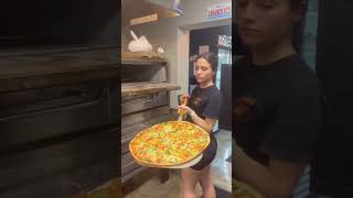 Pizza Girl Rotating The Pizza To Get The Under Carriage On Point Best Bar Pie In Florida 