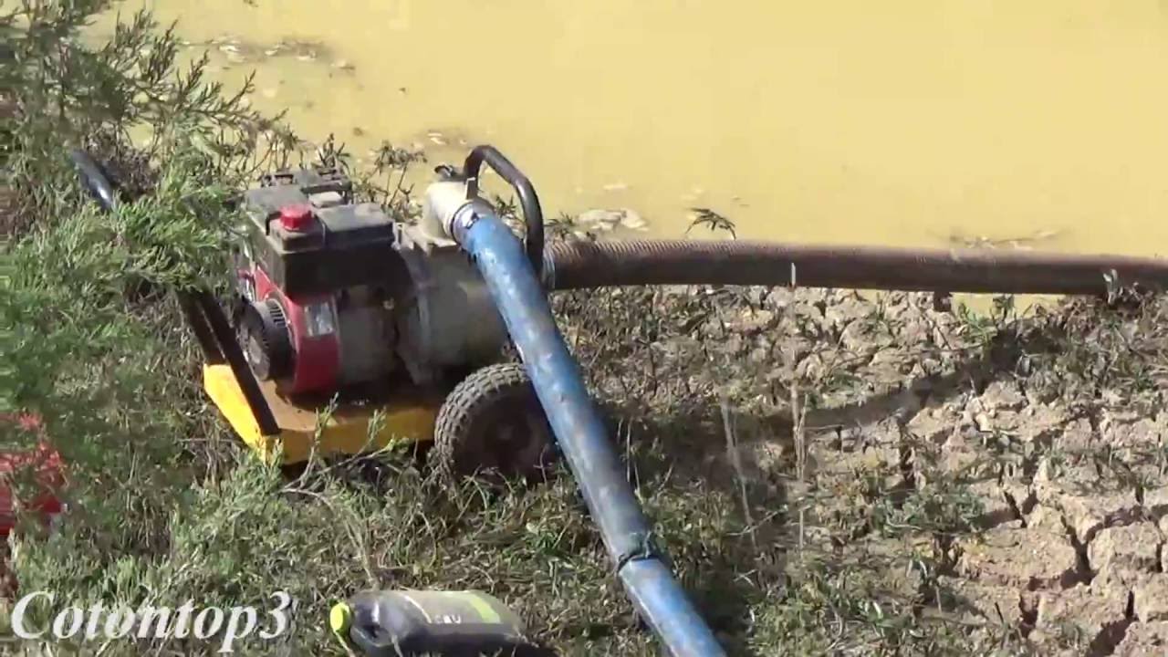 Using a trash pump to drain a pond and a john deere excavator digging