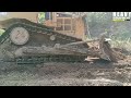 Highly Experienced Caterpillar D6R XL Bulldozer Operator Works To Widen Road On Plantation Highly Experienced Caterpillar D6R XL Bulldozer Operator Works To Widen Road On Plantation