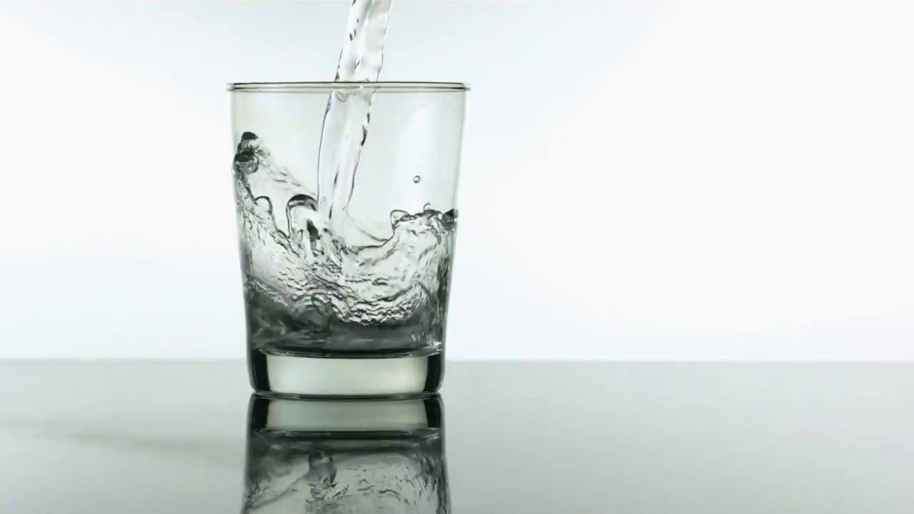 Water pouring into glass slow motion' royalty free HD stock video