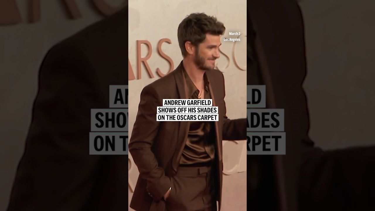 Andrew Garfield shows off his shades on the Oscars carpet