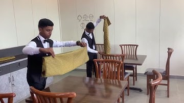 Laying of Table cloth .