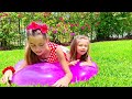 Stacy and Artem play with a huge inflatable ball