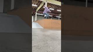 Inline skater grinds ledge at skatepark and lands awkwardly on his leg