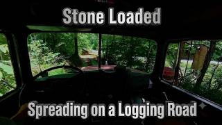 Mack DM Spreading Stone on a Logging Road