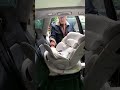 A new father immersively arranges a safety seat to create a special car space for his baby
