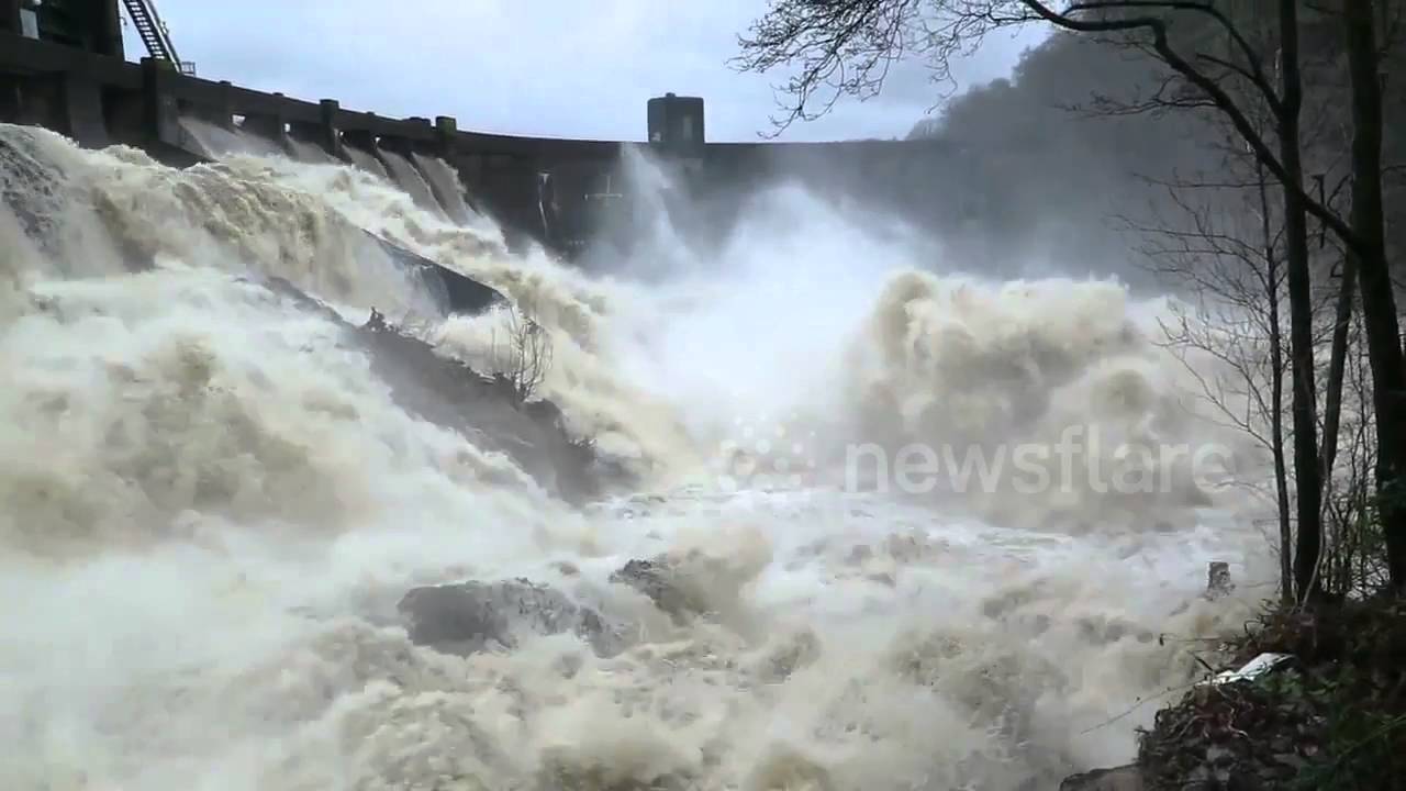 Powerful floodwater rushes over dam in Scotland