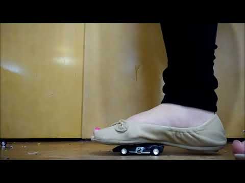 Giantess demolishes tiny race car