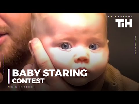 Baby Stares at Herself in Mirror Without Blinking While Dad Holds her Up