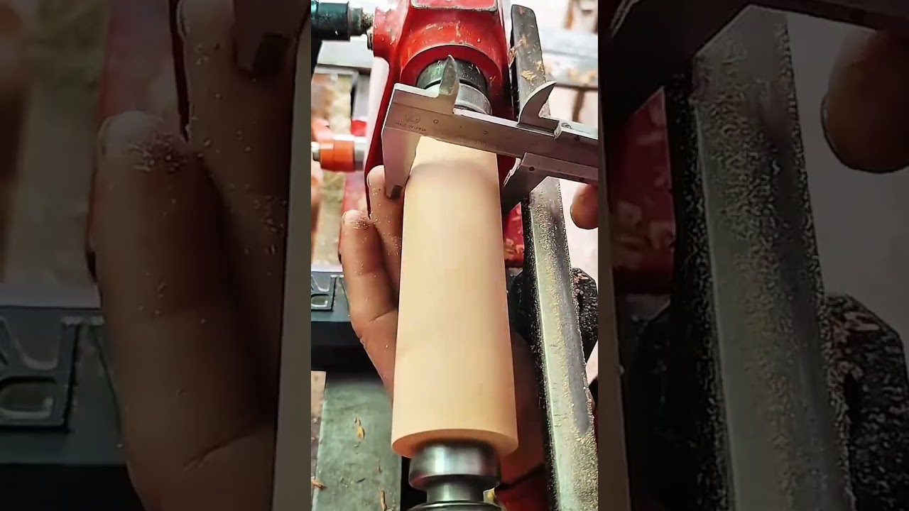 Turning a wooden blank on a lathe to shape it into a smooth, round cylinder