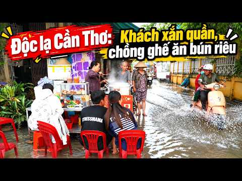 Unique: Diners roll up pants and stack chairs to eat bun rieu amidst Can Tho tidal flooding