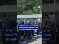 A group of masked people stops traffic at UK port | DW News