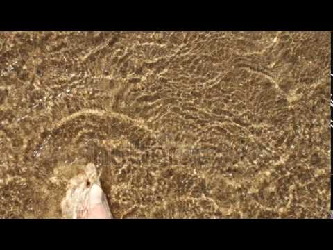 Selfie foots on sand beach with smooth wave texture background. Morphing animations, motion.