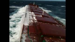 Capesize bulk carrier on heavy seas at Pacific Ocean.