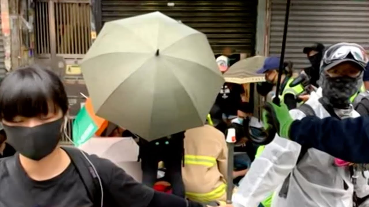 newspaper mockup HK demonstrators marching with masks in defiance of anti-mask law