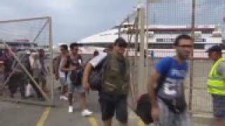 Refugees board ferry bound for Piraeus