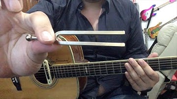 A Traditional way of tuning a guitar with a Pitch Fork