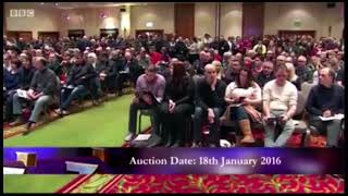 Property Auctioneer Andrew Binstock Expertly Handles a Woman Putting her Coat on