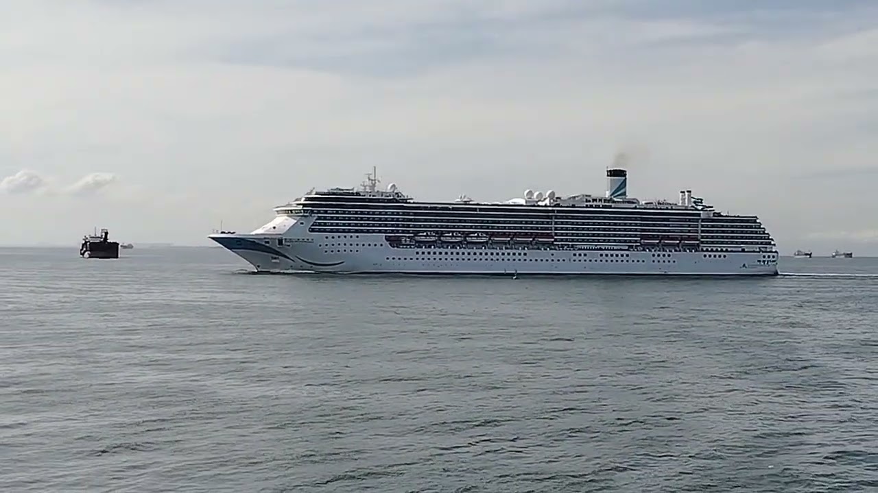 @manila bay anchorage,cruise ship passing by in the channel