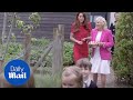 Kate Middleton and Dr Jill Biden watch school children feed rabbits