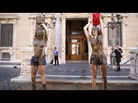 Topless activists pour mud on themselves in Rome amid Europe-wide climate protests