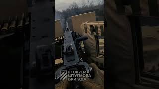 Ukrainians opens fire on Russians using a .50 calibre machine-gun on an American MRAP vehicle image