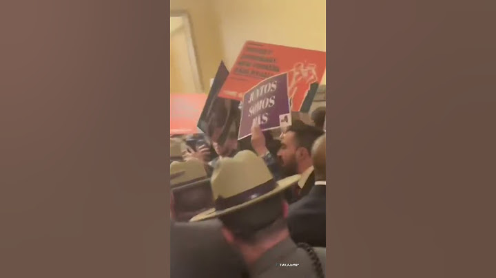 Border czar casually eats apple as protesters erupt in anger