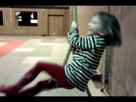 little girl swinging on a rope