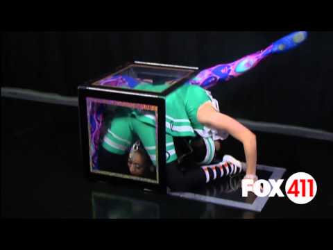 Two Big Apple Circus contortionists squeeze into a small box