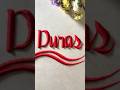 Writing the word Duras in sand