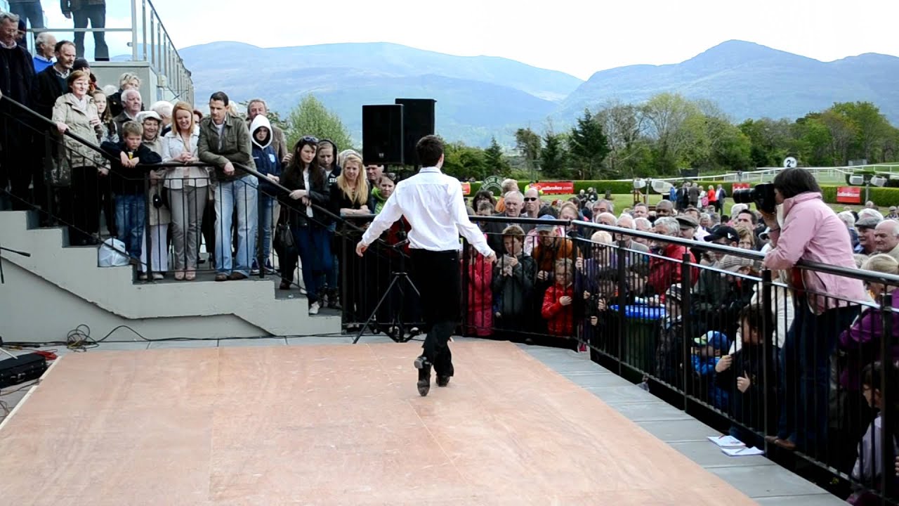 David Geaney dancing with Hector O hEochagain and Micheal O Muircheartaigh at Killarney Racecourse