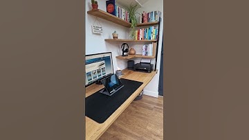 Custom oak table and floating shelves for this home office workspace.